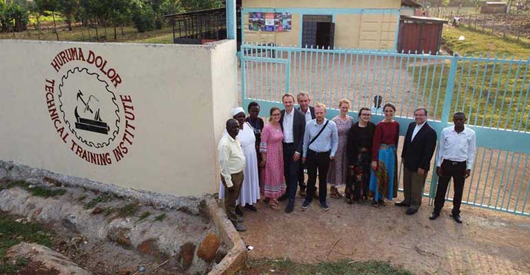 Mission partners at the Huruma Dolor Technical Training Institute gate